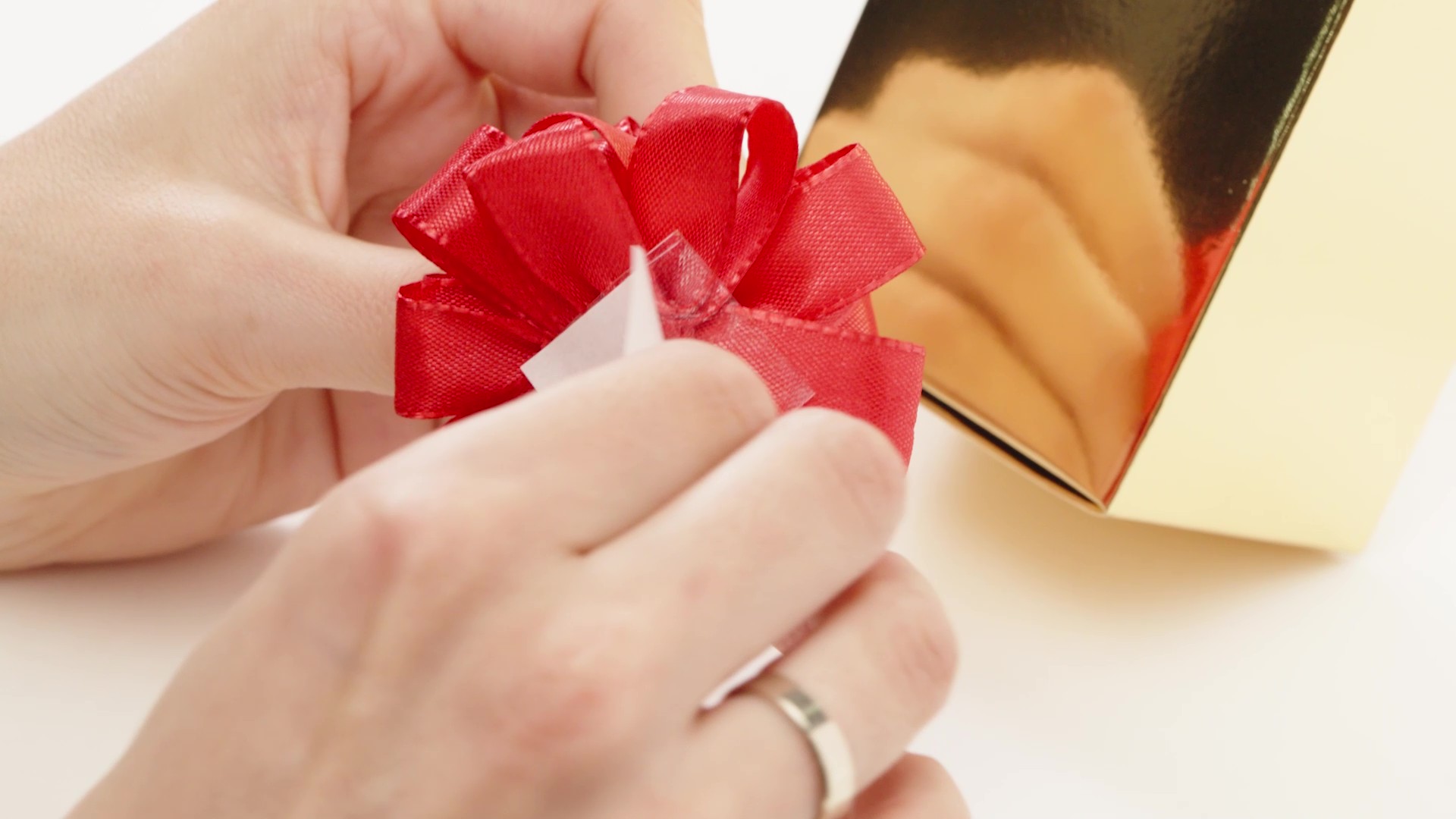 Peel the protective film off the adhesive dot
